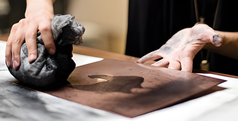 Bronze sheet being cleaned