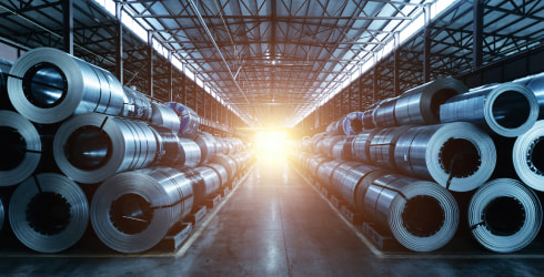 Rolls of steel sheet stacked in a warehouse